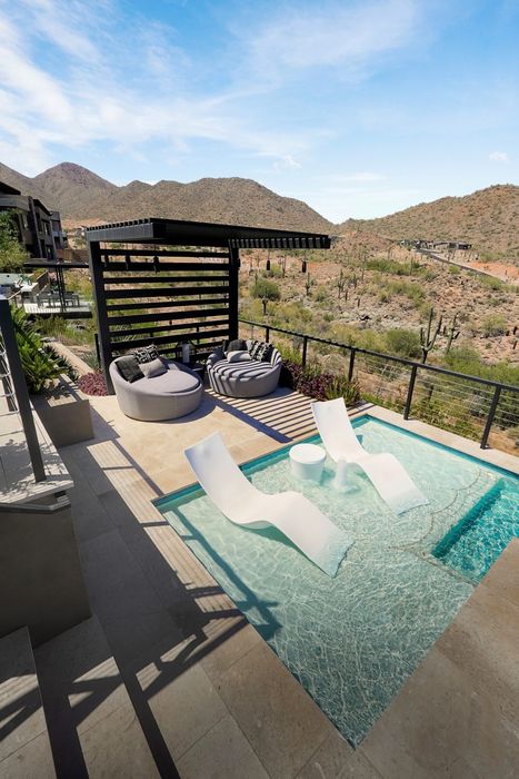 Shaded daybeds off the pool deck