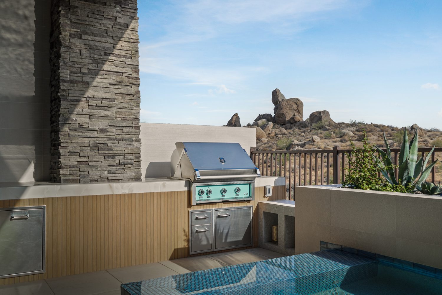 Stacked natural stone veneer catching raking desert light
