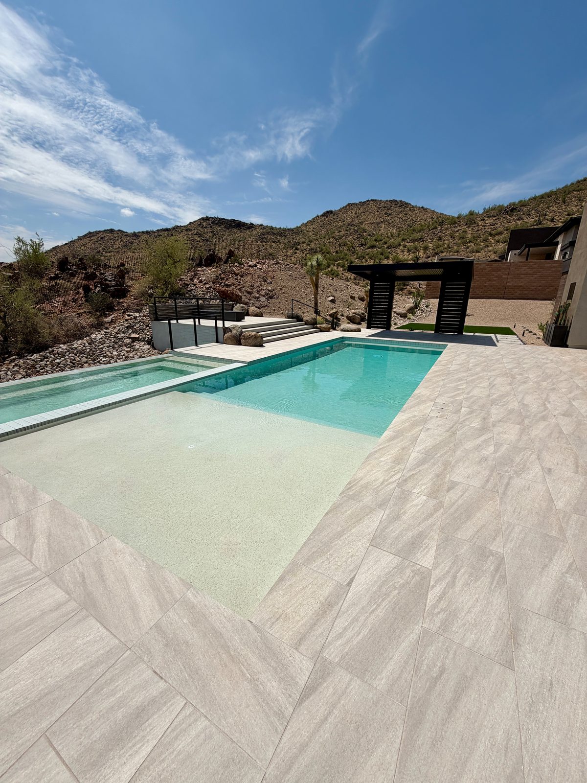 Pool with Baja shelf and mountain views beyond the deck